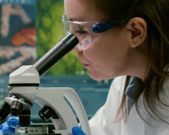 Portrait of biologist scientist in white coat working in expertise laboratory