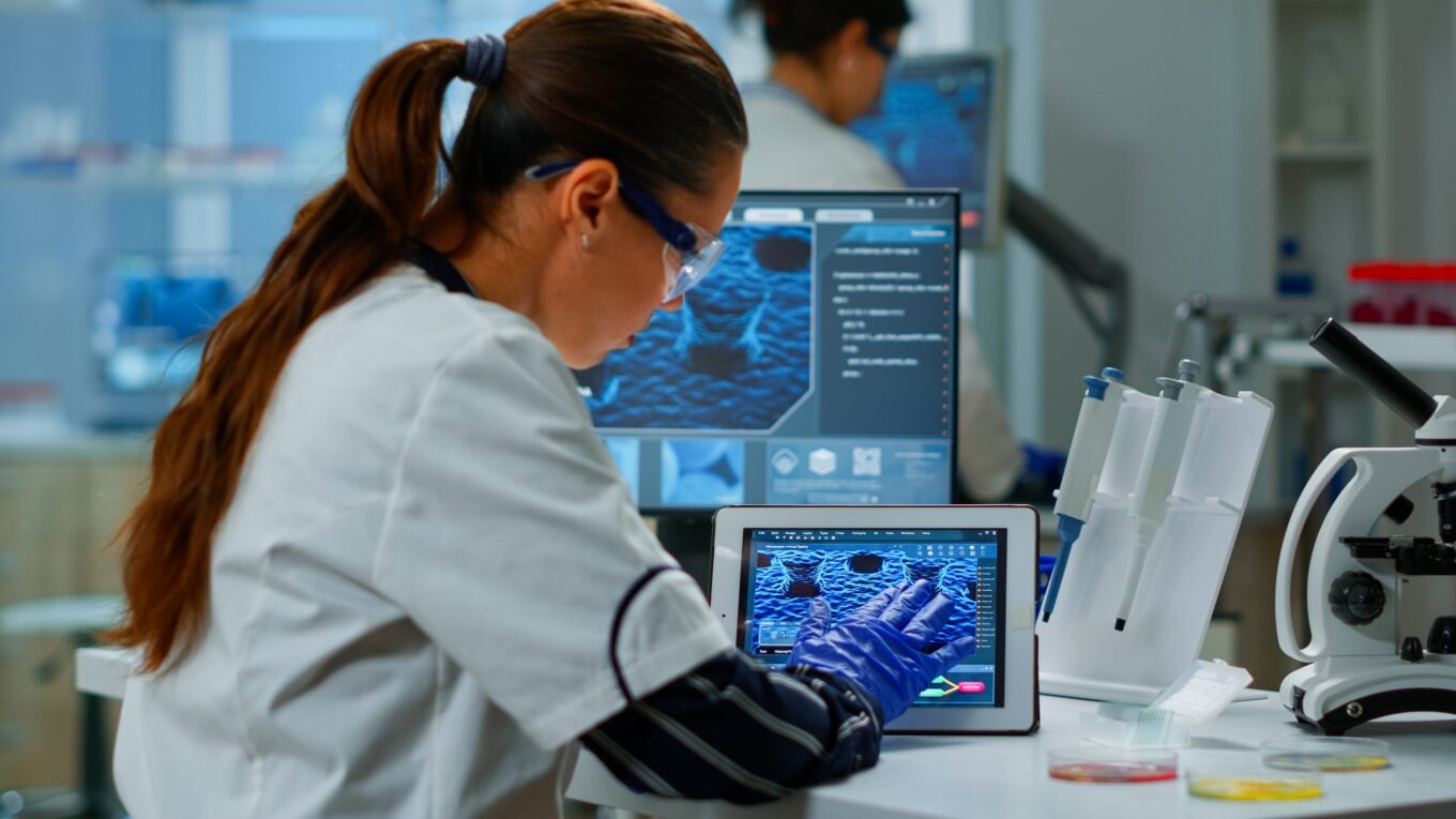 Scientist using digital tablet working in modern medical research laboratory